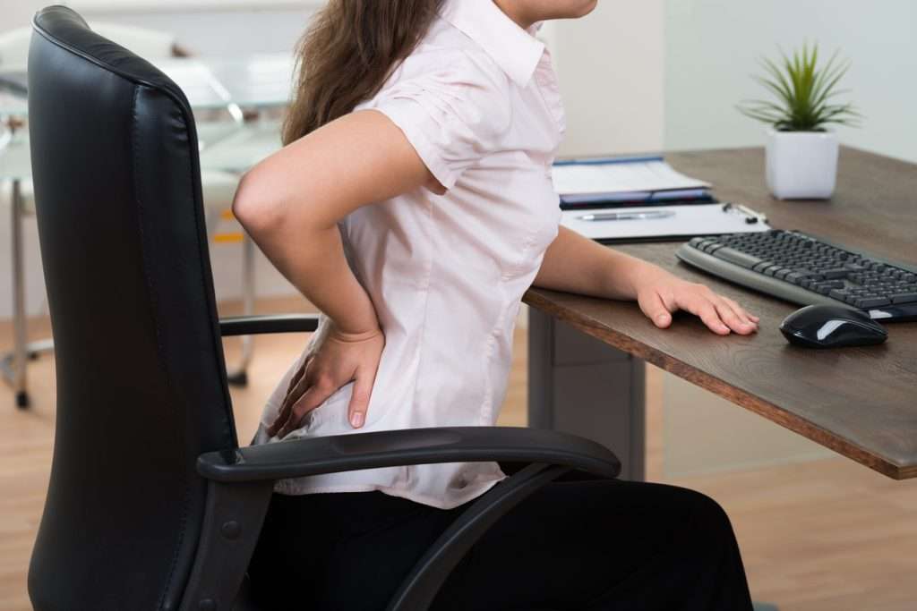 Businesswoman Having Backpain at desk